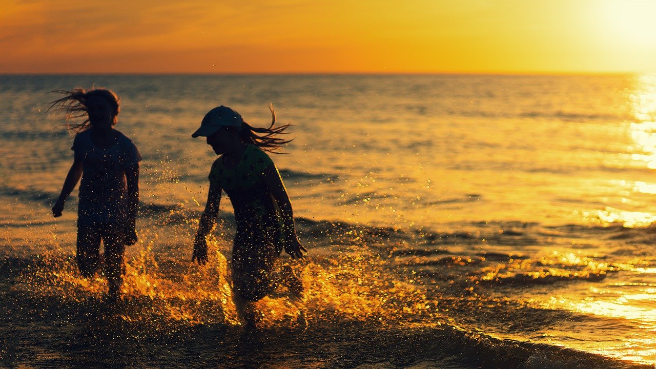 Two girls playing near ourOrange Beach Beachfront Rentals