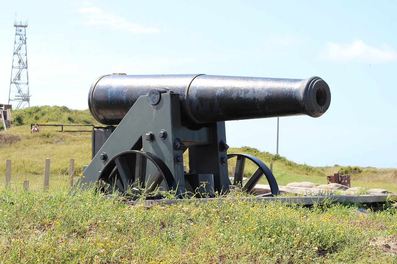 An old cannon on a grassy plain at the Fort Morgan Historic Site