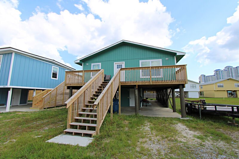 The exterior of one of our rentals, blue with high staircase