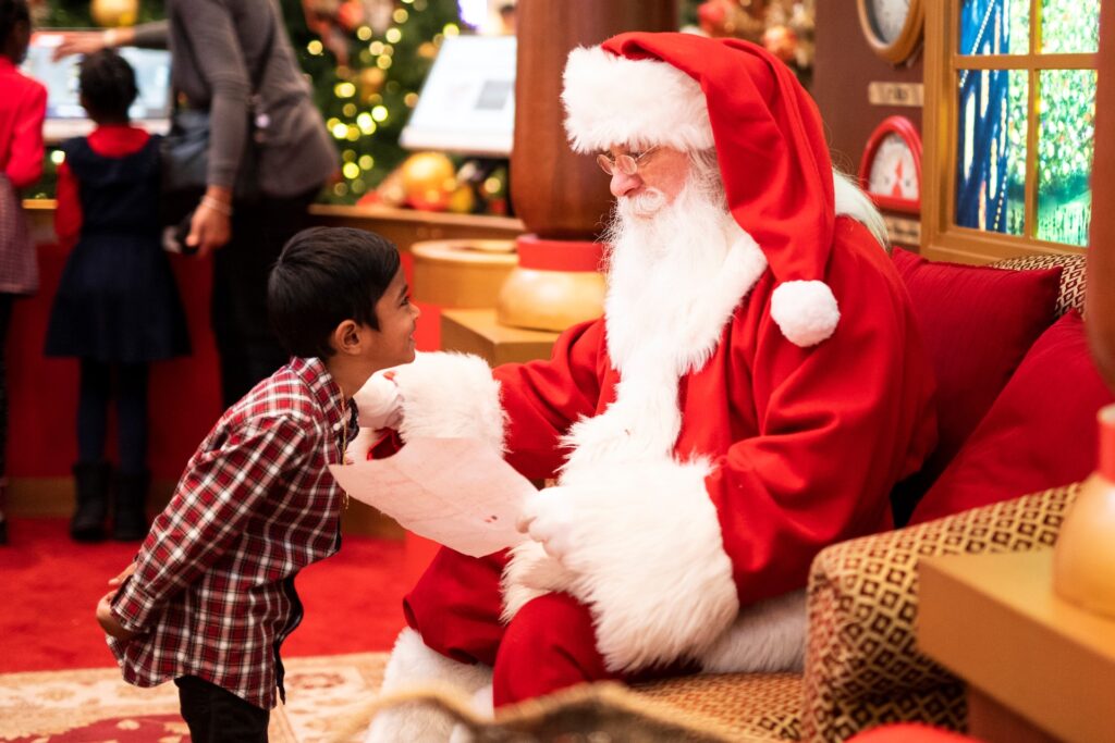 Child taking a Christmas picture with Santa